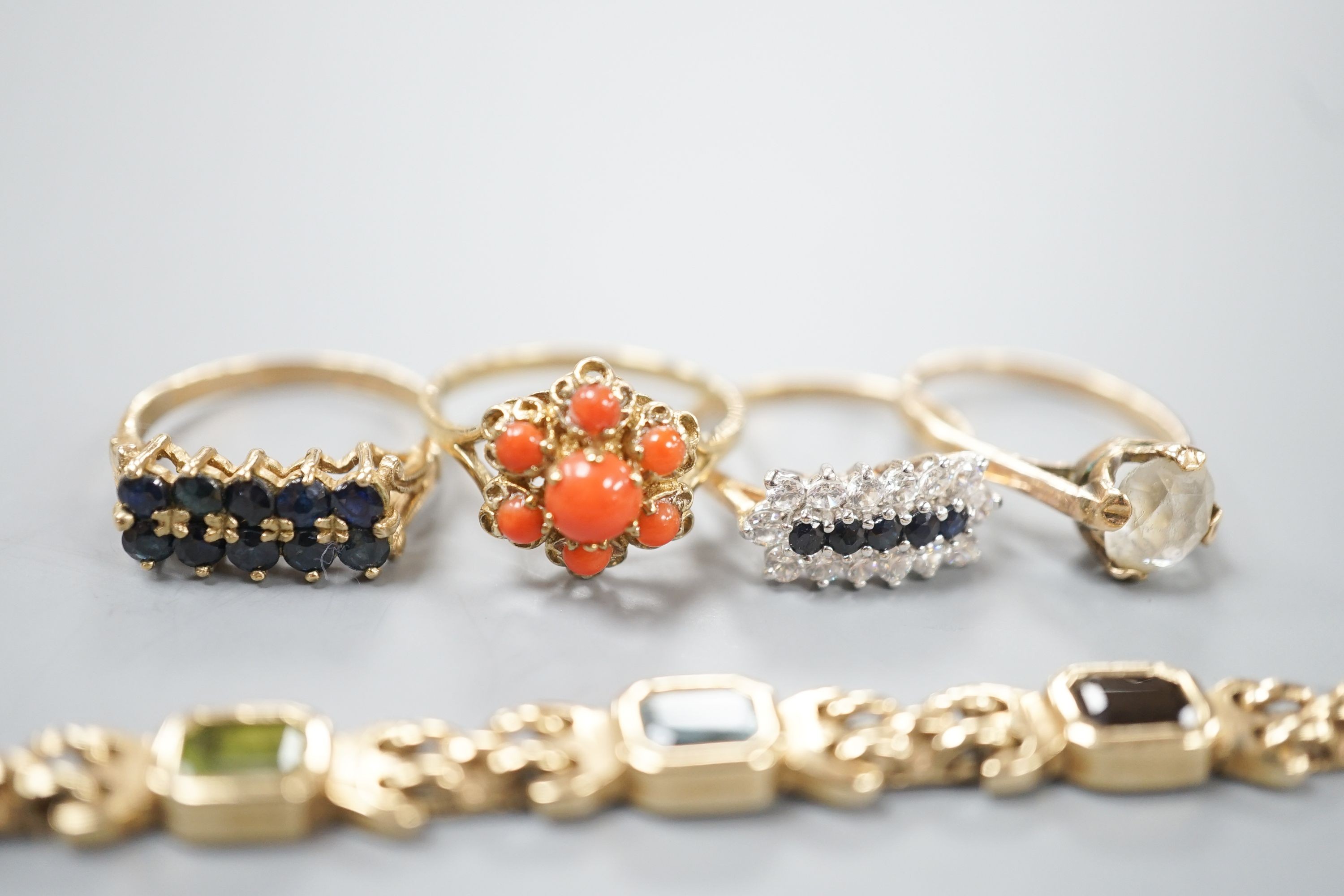 A modern 9ct gold and gem set bracelet and four assorted 9ct gold dress rings, gross 24.8 grams